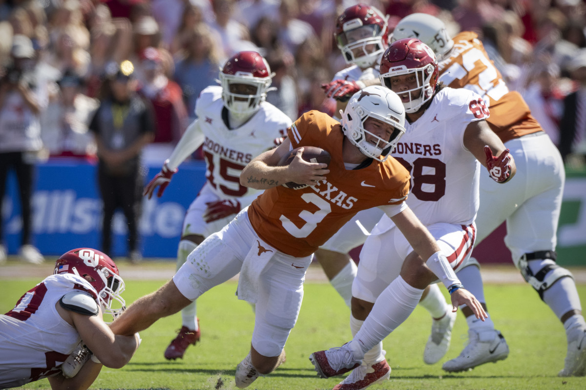 Texas Longhorn QB Quinn Ewers gets tackled on Saturday in Dallas against Oklahoma. 